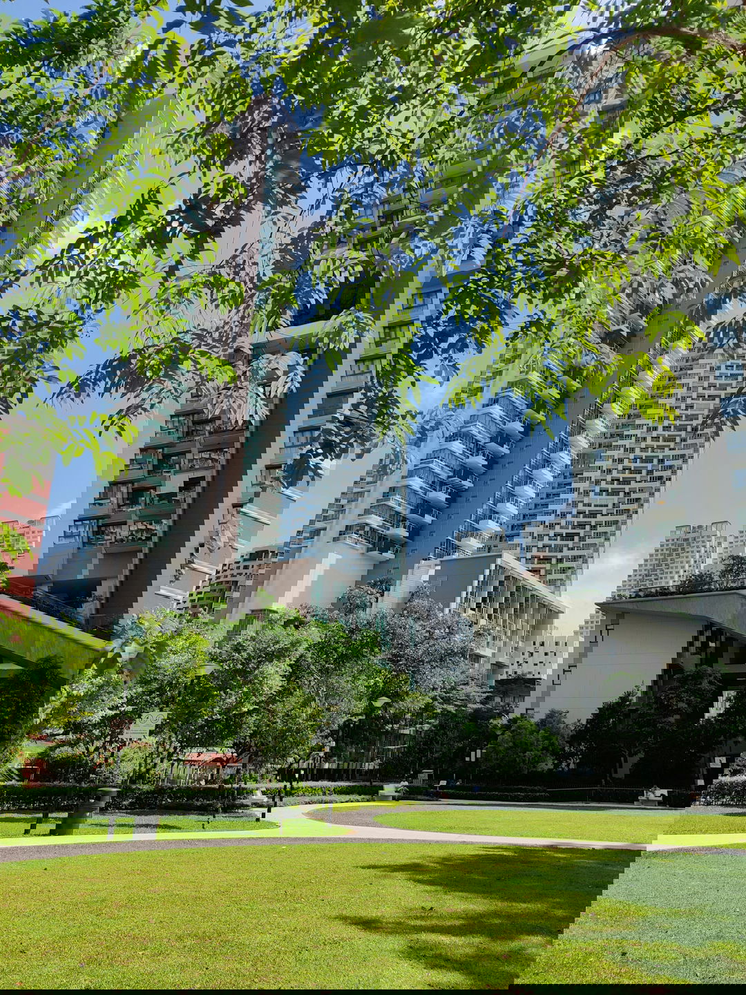 green grass field near white concrete building during daytime
